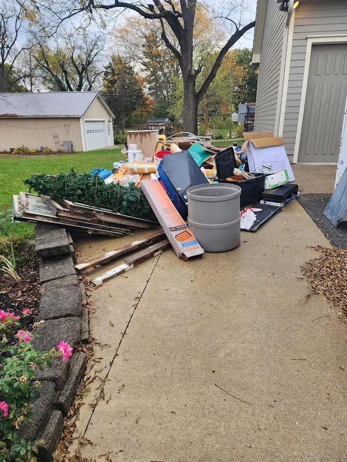 Dumpster being loaded with debris for Estate Cleanout Dumpster Rental in Champion